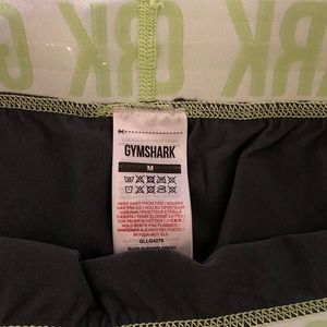 Gymshark. Grey with lime green band biker shorts. Size: medium.